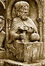Janus Cutting the Epiphany Bread (he's pulling the knife in his right hand toward himself, through the round loaf)
